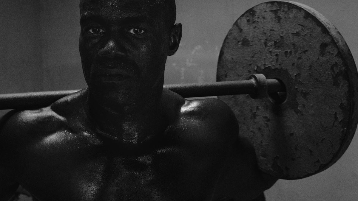 Lifter with a barbell racked on his shoulders